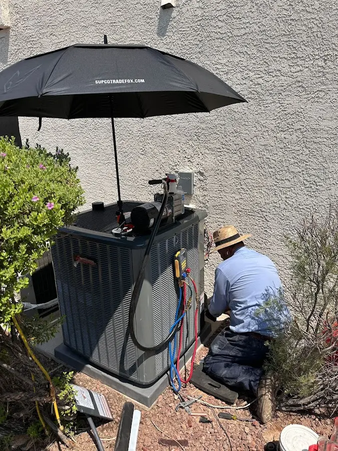 HVAC technician performing outdoor AC maintenance in Waterford